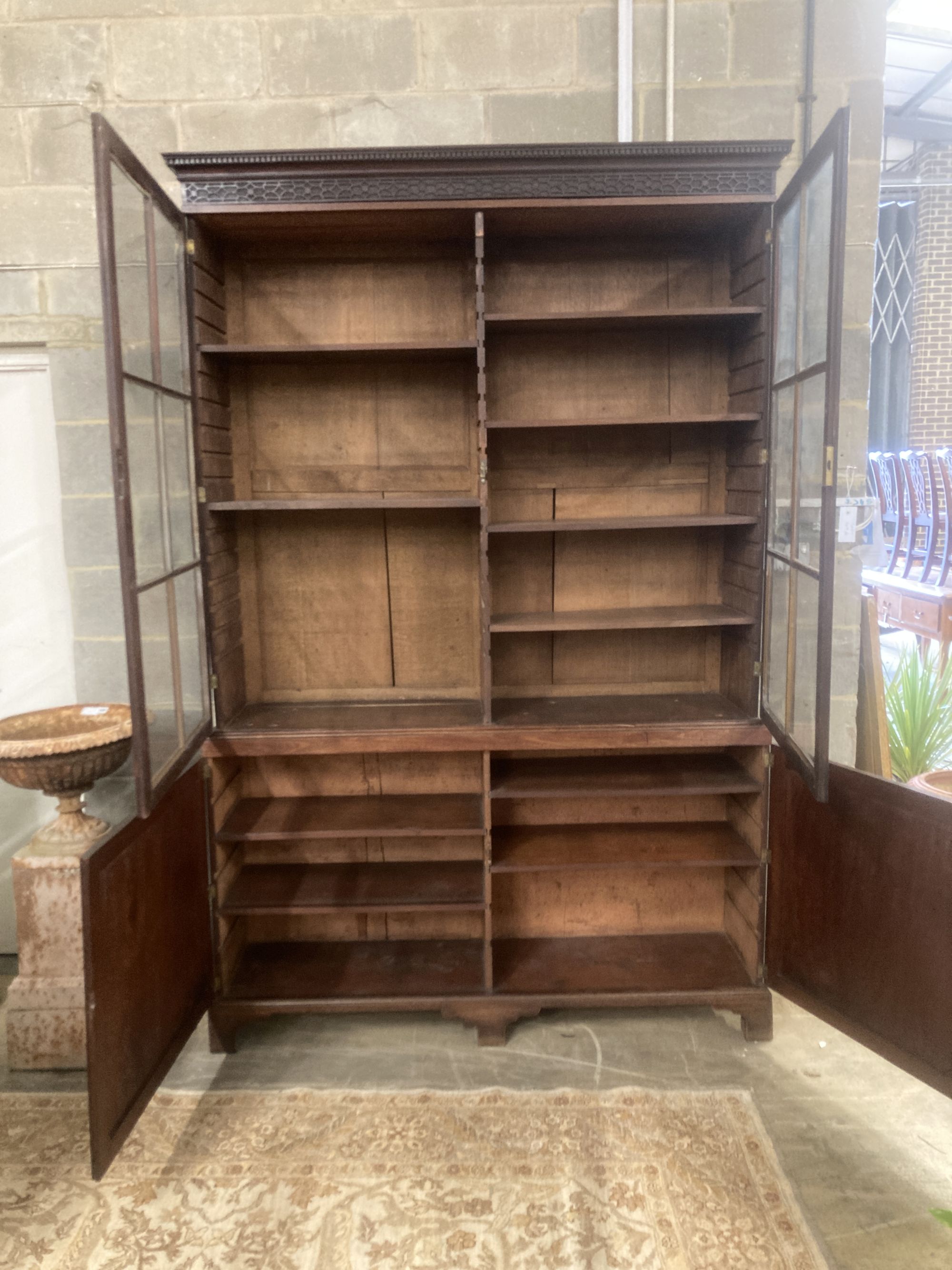 A George III mahogany bookcase cupboard, length 160cm, depth 40cm, height 245cm